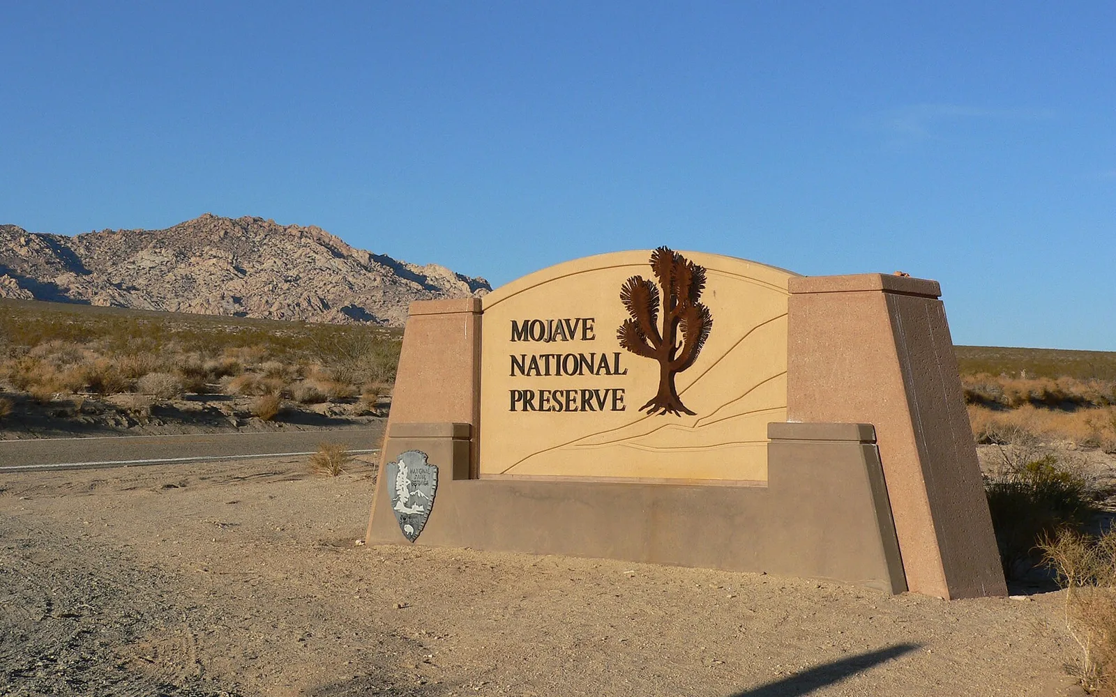 Mojave National Preserve sign and desert landscape; regional outdoor-recreation context.